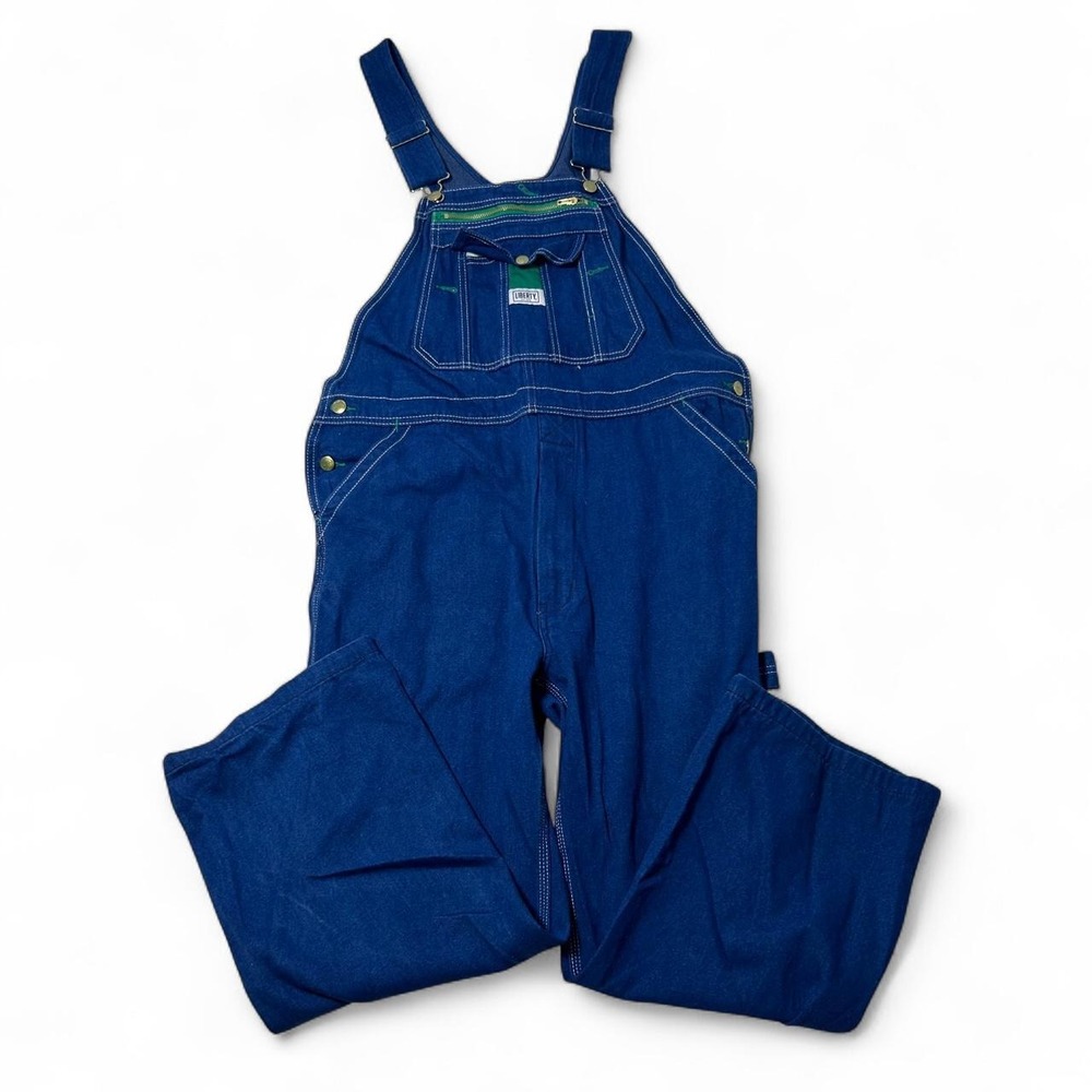 Blue denim overalls with white stitching